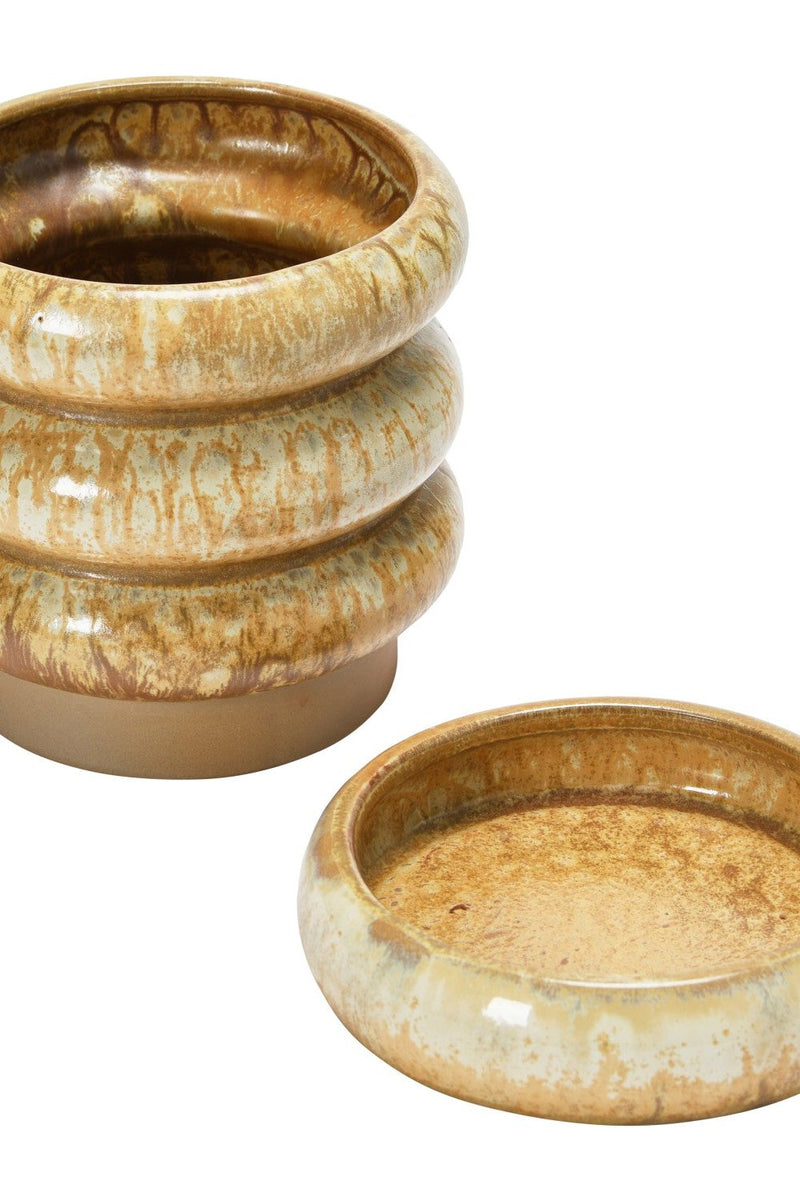 The ribbed stoneware planter shown with its two parts separated and in to both from the sides.