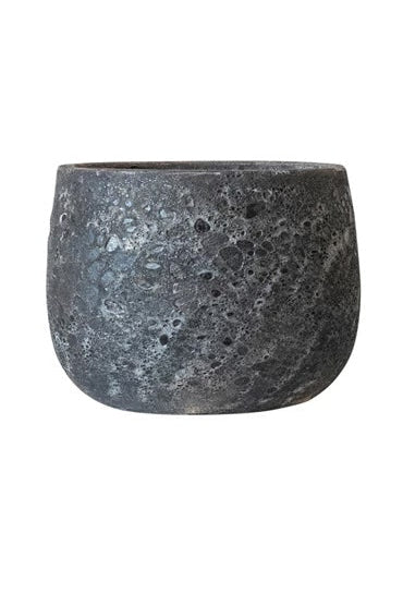 A black round pot with a corse glaze in front of a white background ©Creative Co-Op