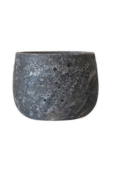 A black round pot with a corse glaze in front of a white background ©Creative Co-Op