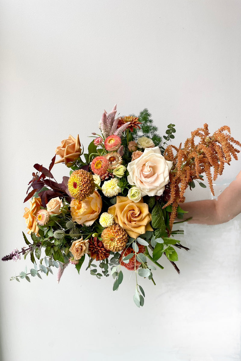 A Dusk floral arrangement in August featuring mustard yellow tones and zinnias 