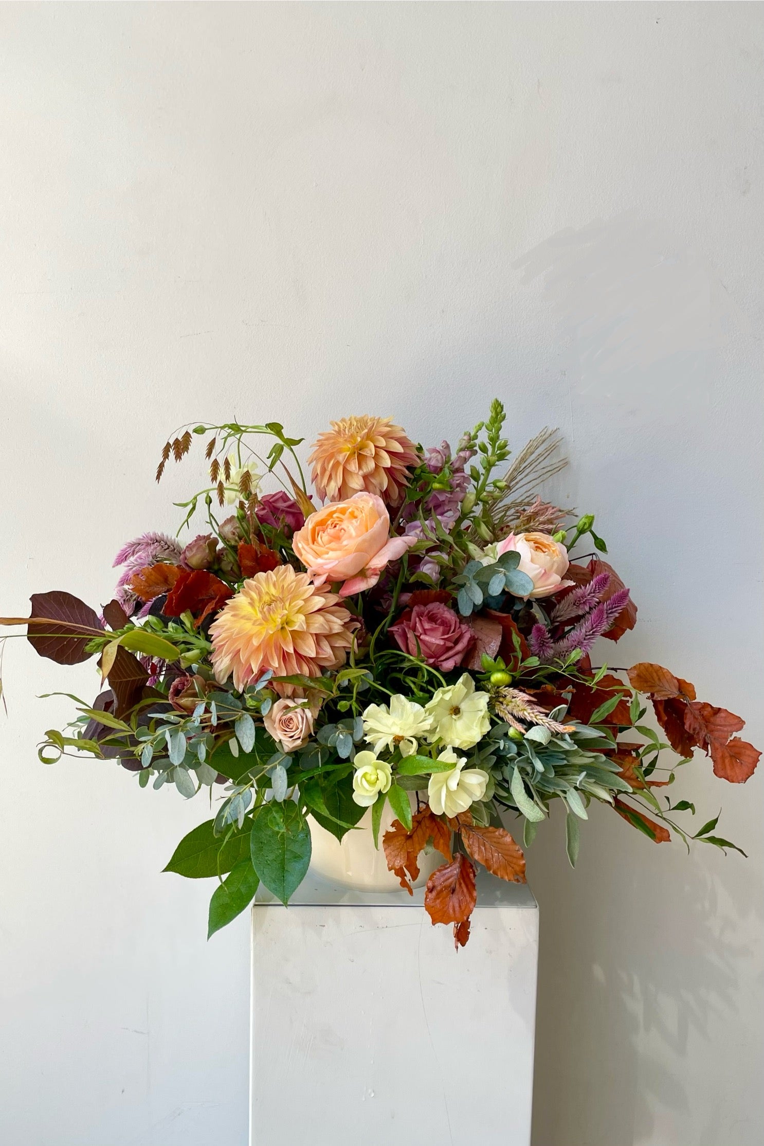 A September Dusk arrangement featuring fall foliage and dahlia with garden rose custom designed by Sprout Home. #size_$200