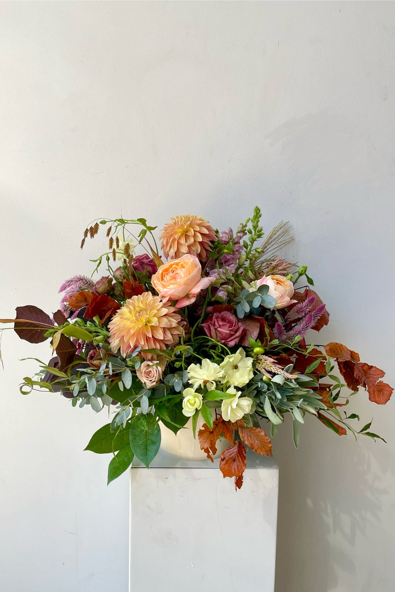 A September Dusk arrangement featuring fall foliage and dahlia with garden rose custom designed by Sprout Home. 