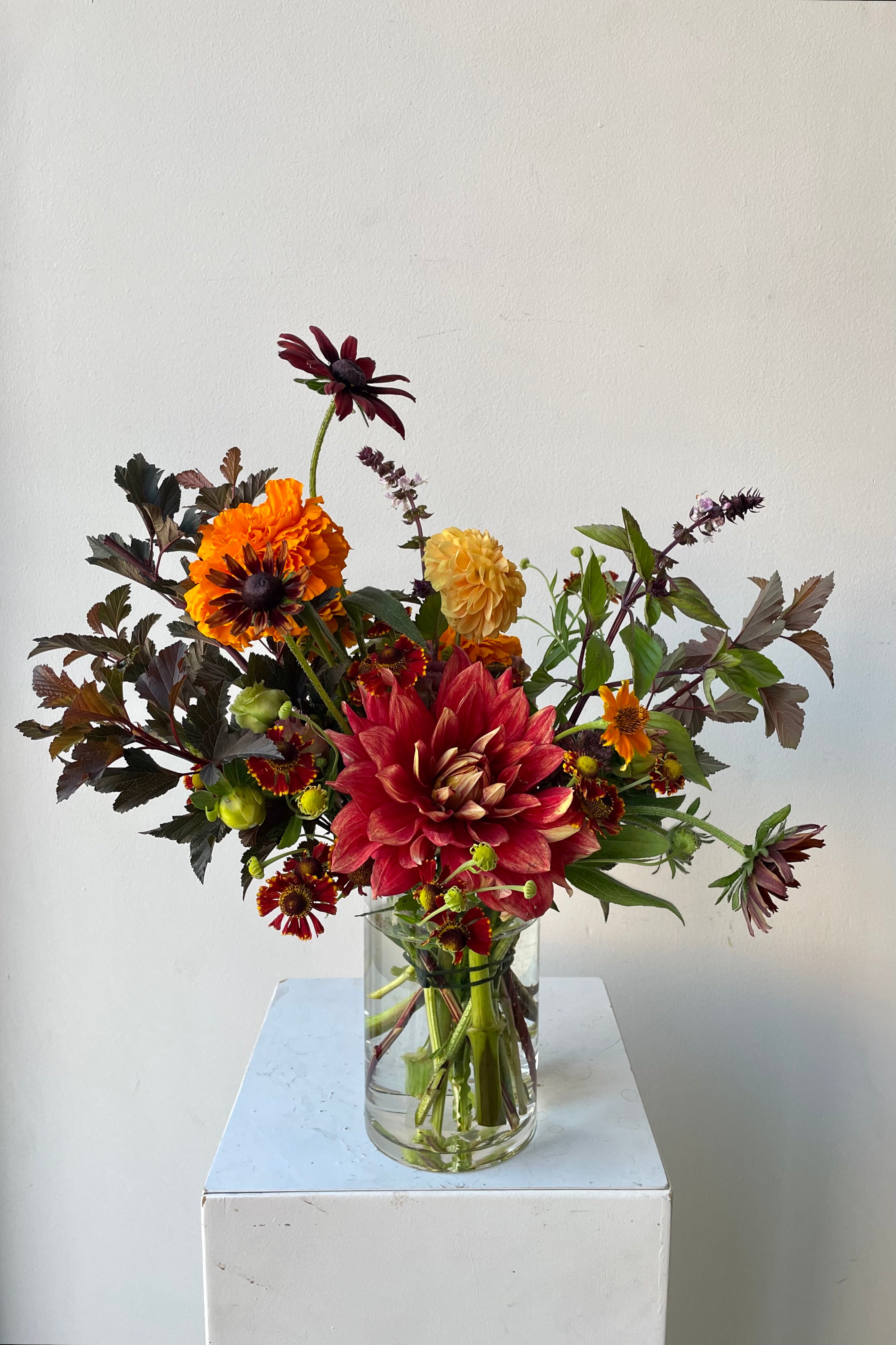 Earth arrangement by Sprout Home featuring dahlia and marigolds in August. #size_$65