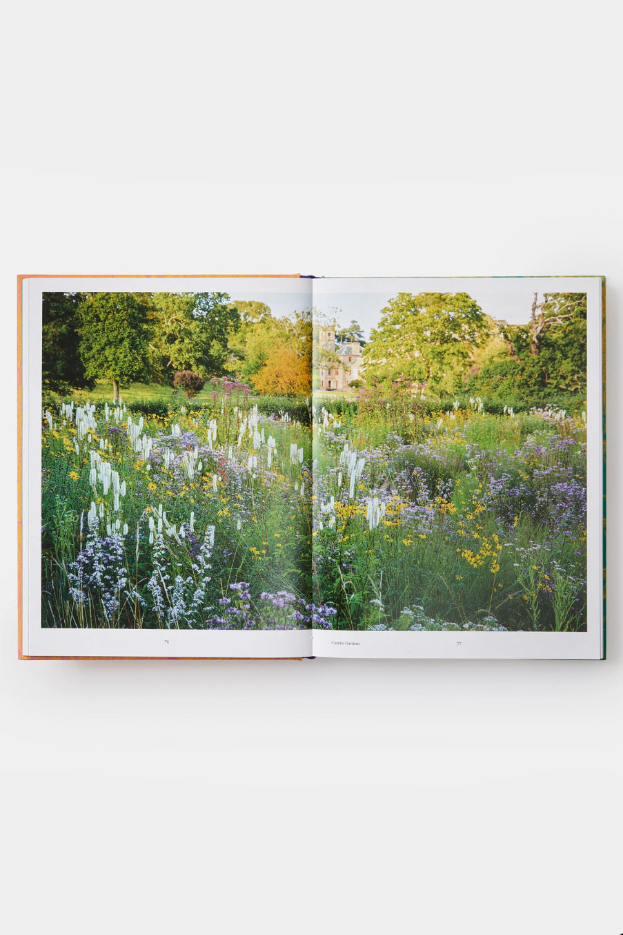 Open Wild: the Naturalistic Garden book showing a photograph of a garden with flowers and trees. ©Phaidon