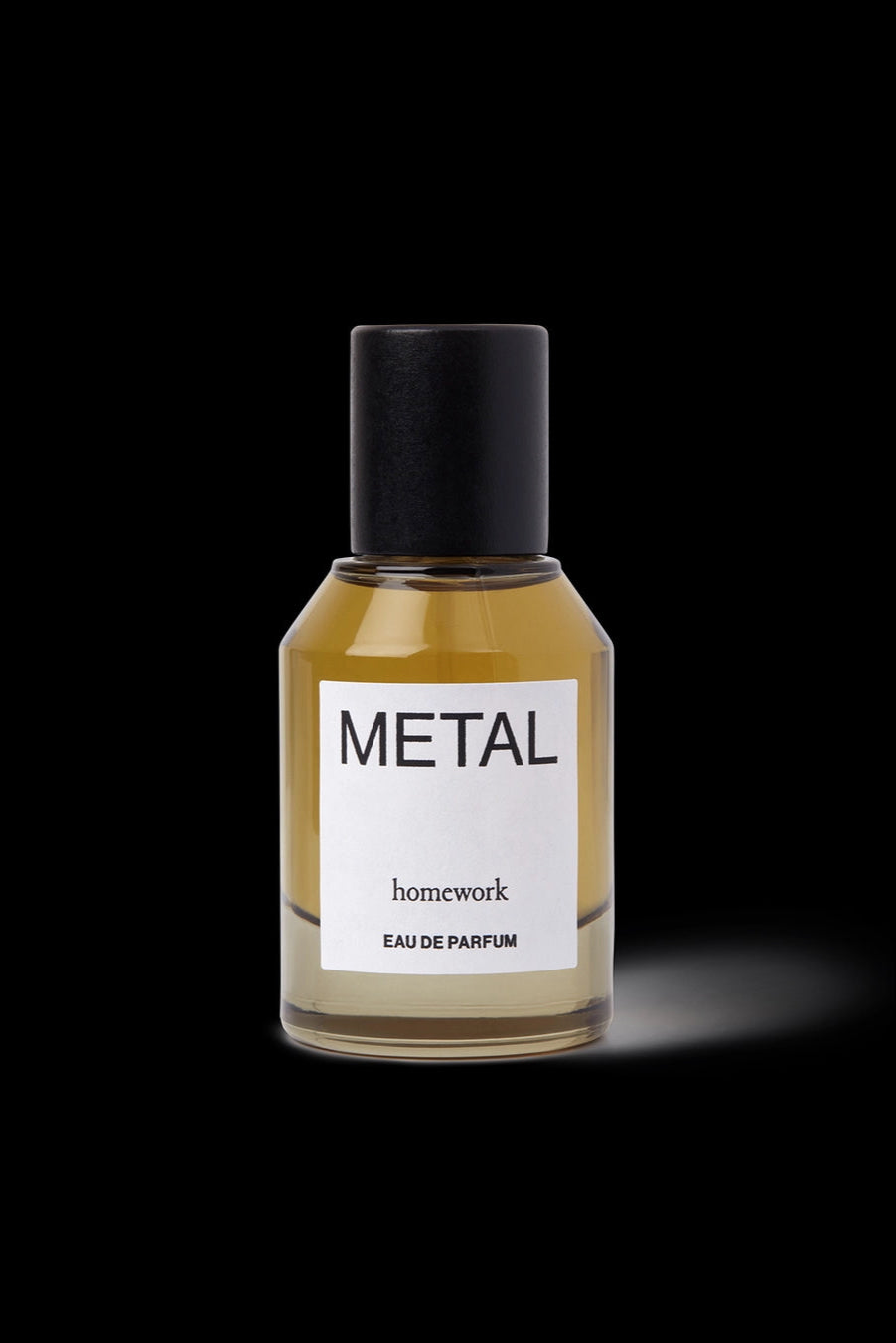 Metal Eau de Parfum Perfume bottle labeled 'Metal' by 'homework' on a black background ©Homework