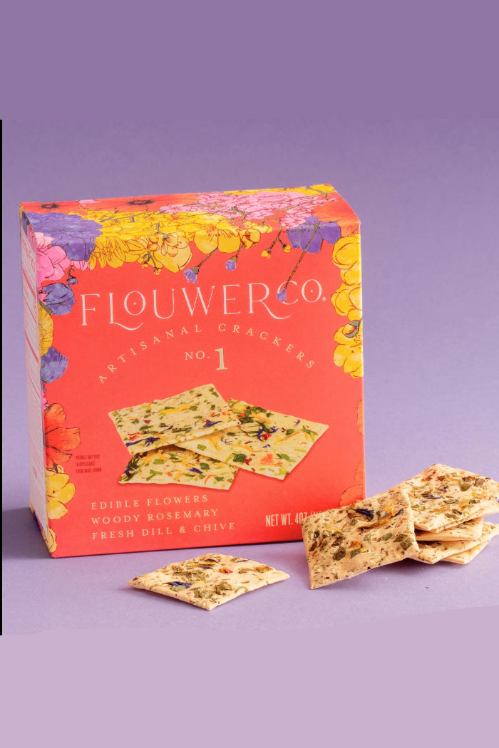 Flouwer Co No. 1 artisanal crackers packaging with crackers on a purple background  ©Flouwer Co