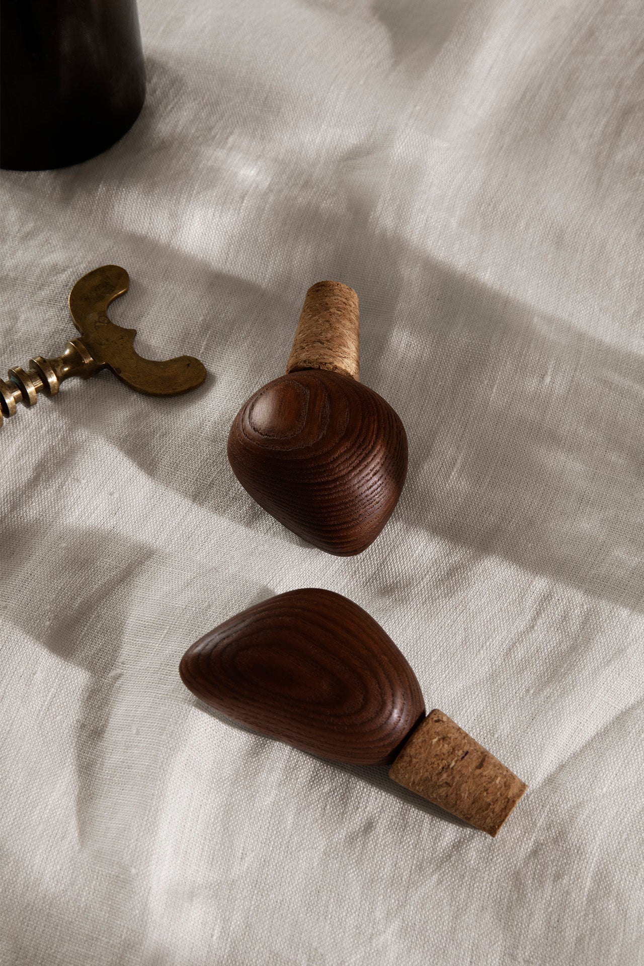 Cairn Wine Stoppers Dark Brown on linen ©Ferm Living