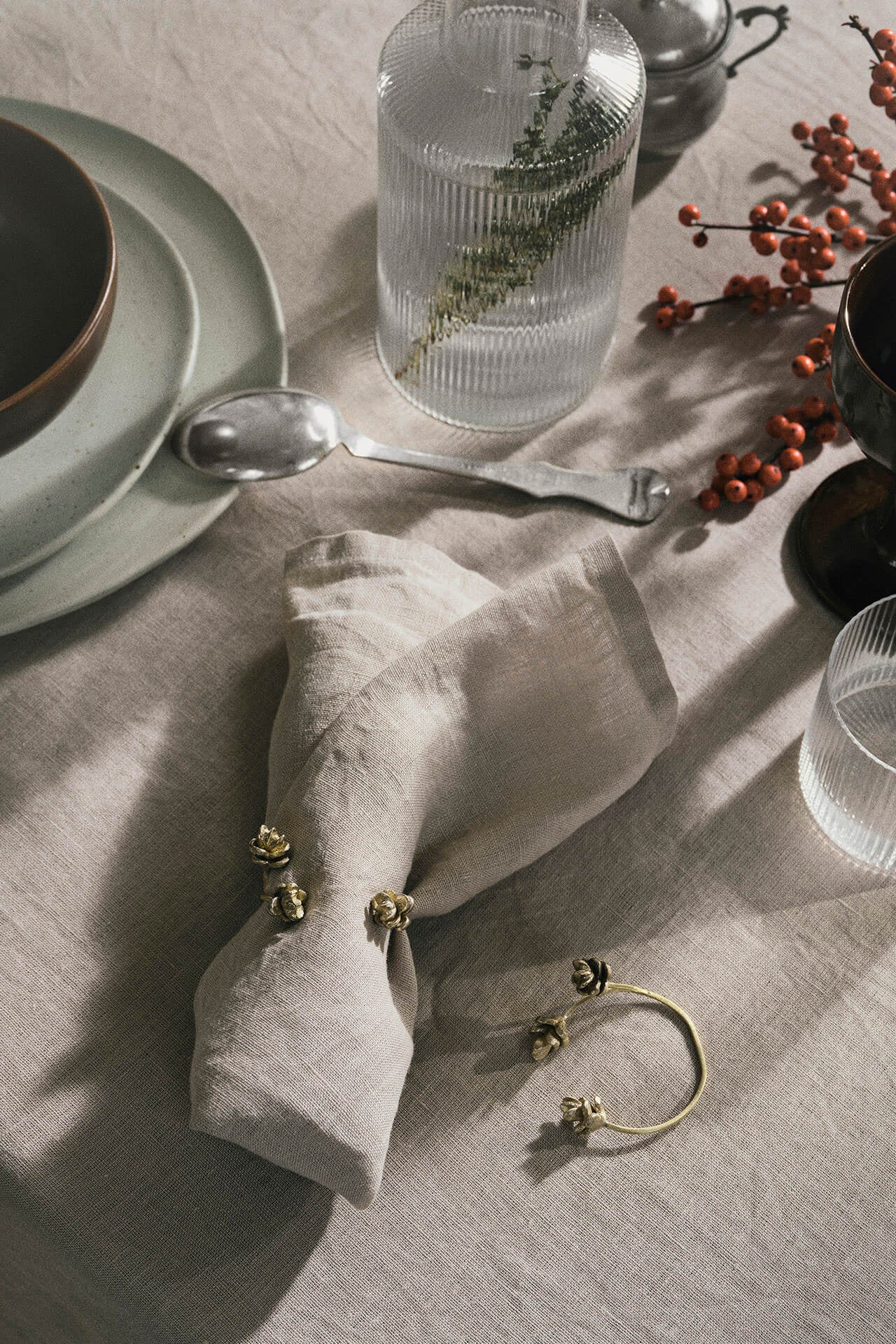 Forest Napkin Rings Brass being used on a table setting ©Ferm Living