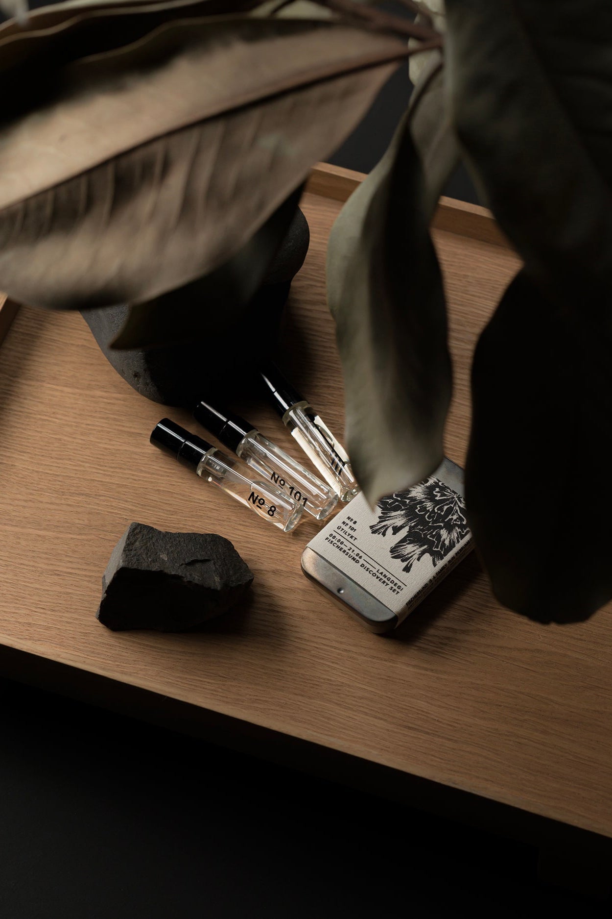 Fischersund's Light Discovery Perfume set sitting on a wood tray with the three perfumes out of its canister ©Fischersund