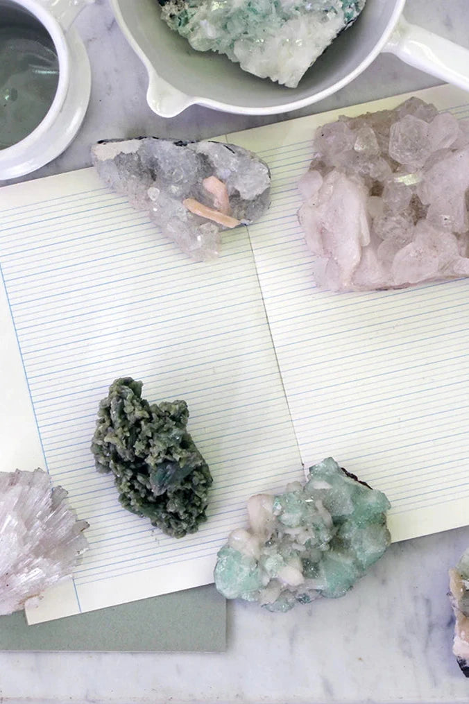 a variety of Zeolite on a lined notebook shown from above. 