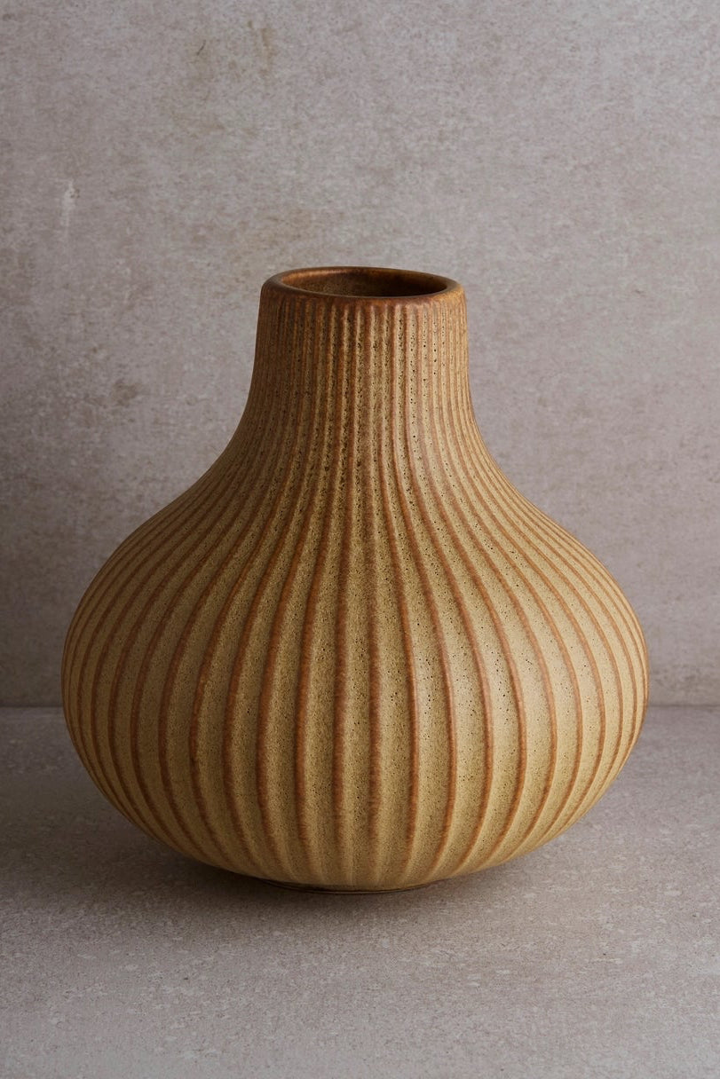 Fluted vase against a gray backdrop ©Goodies