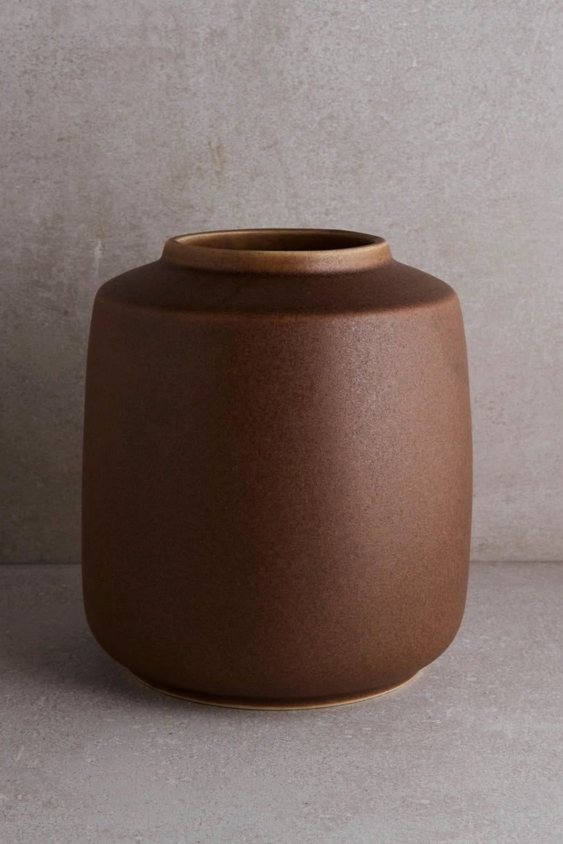 Brown Vase shown at eye level against a gray background ©Goodies