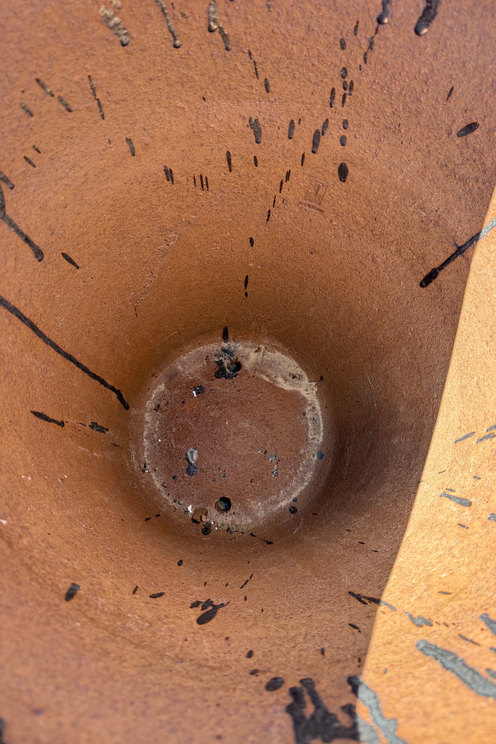 Close-up of the drainholes looking inside of the Graphite Tall Taper Planter Large ©Sprout Home