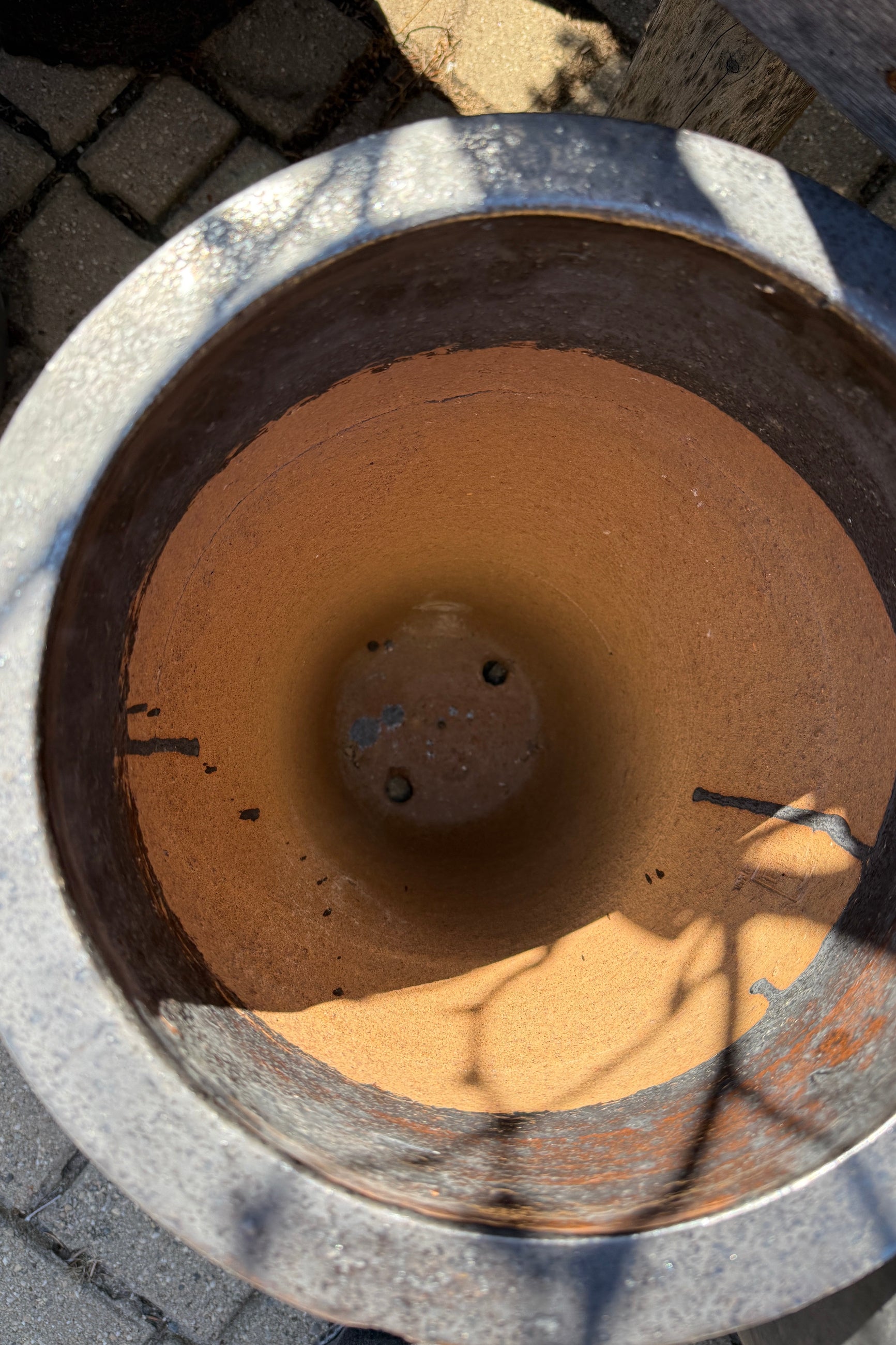 the interior looking in at the drainholes of a Graphite Tall Taper Planter Small ©Sprout Home