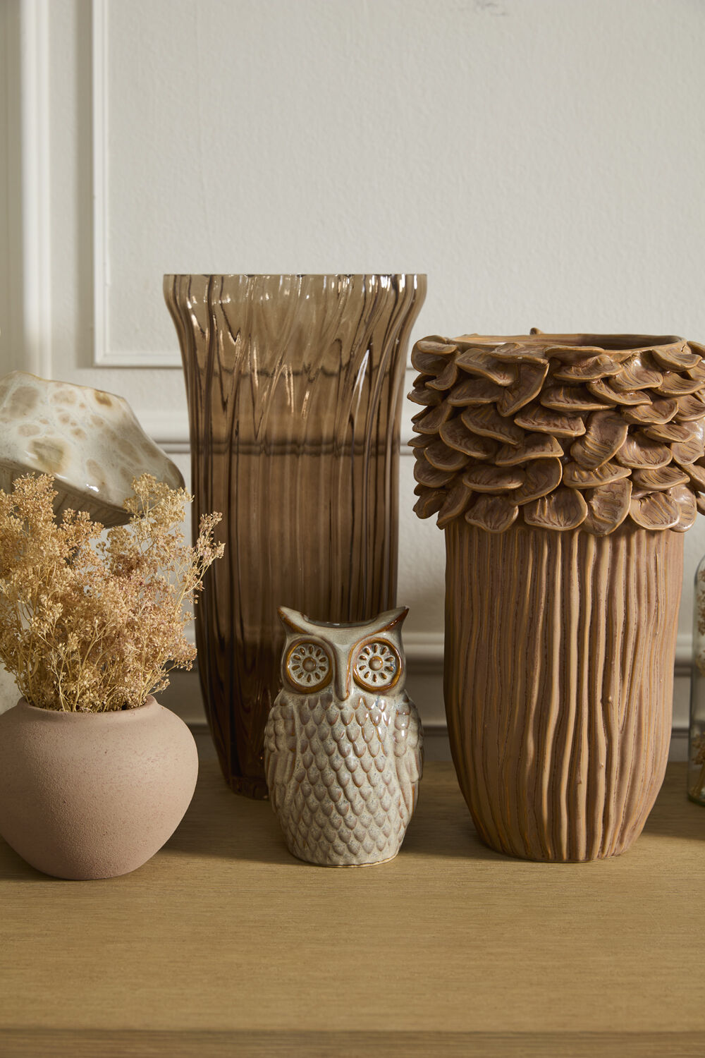 Decorative vases and owl figurine on a wooden surface with a neutral background ©Accent Decor