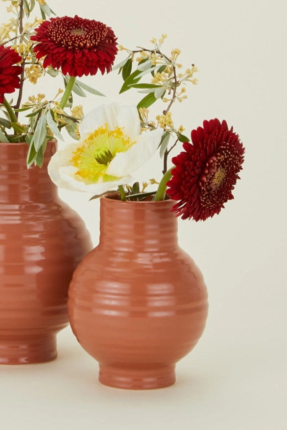 Essential Terracotta Ceramic Vase Small in front of a large with flowers in them on by Hawkins New York ©Hawkins New York