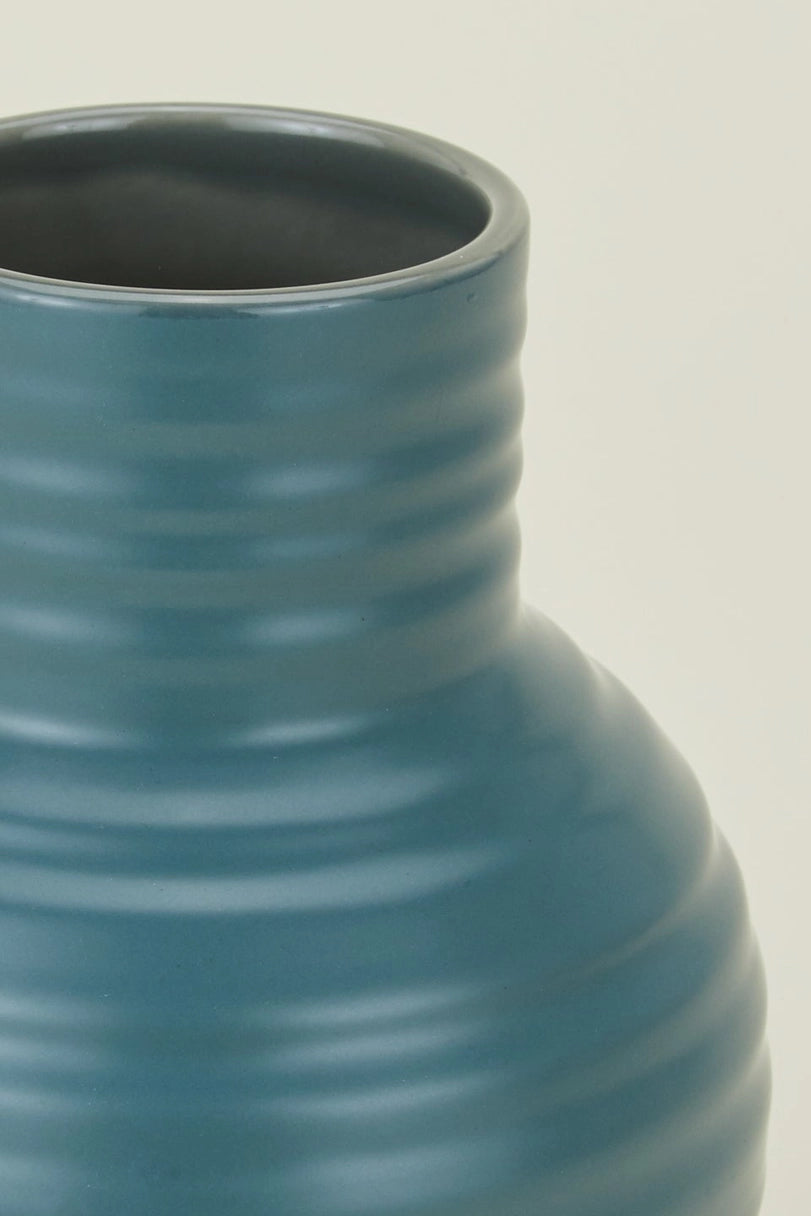 Hawkins New York Essential Peacock Ceramic Vase with ribbed texture on a beige background ©Hawkins New York