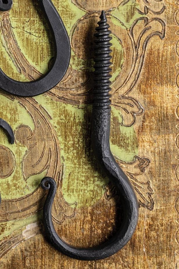 Threaded Blacksmith hook on a yellow and brown tapestry