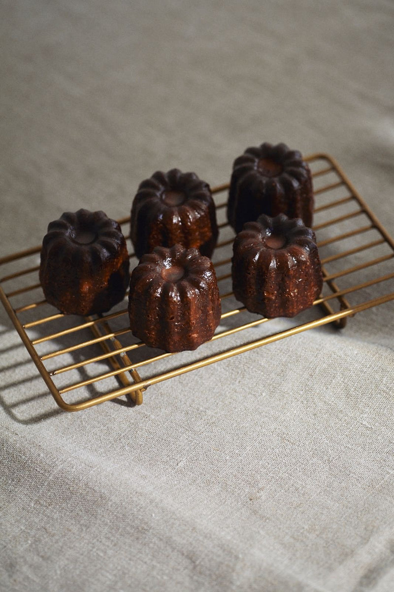 Brass rectangular wire rack with some chocolate baked sweets on top by Fog Linen Works. 