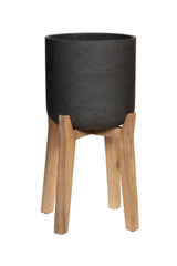 Black Charlie Pot with legs by Pottery Pots against a white wall. 