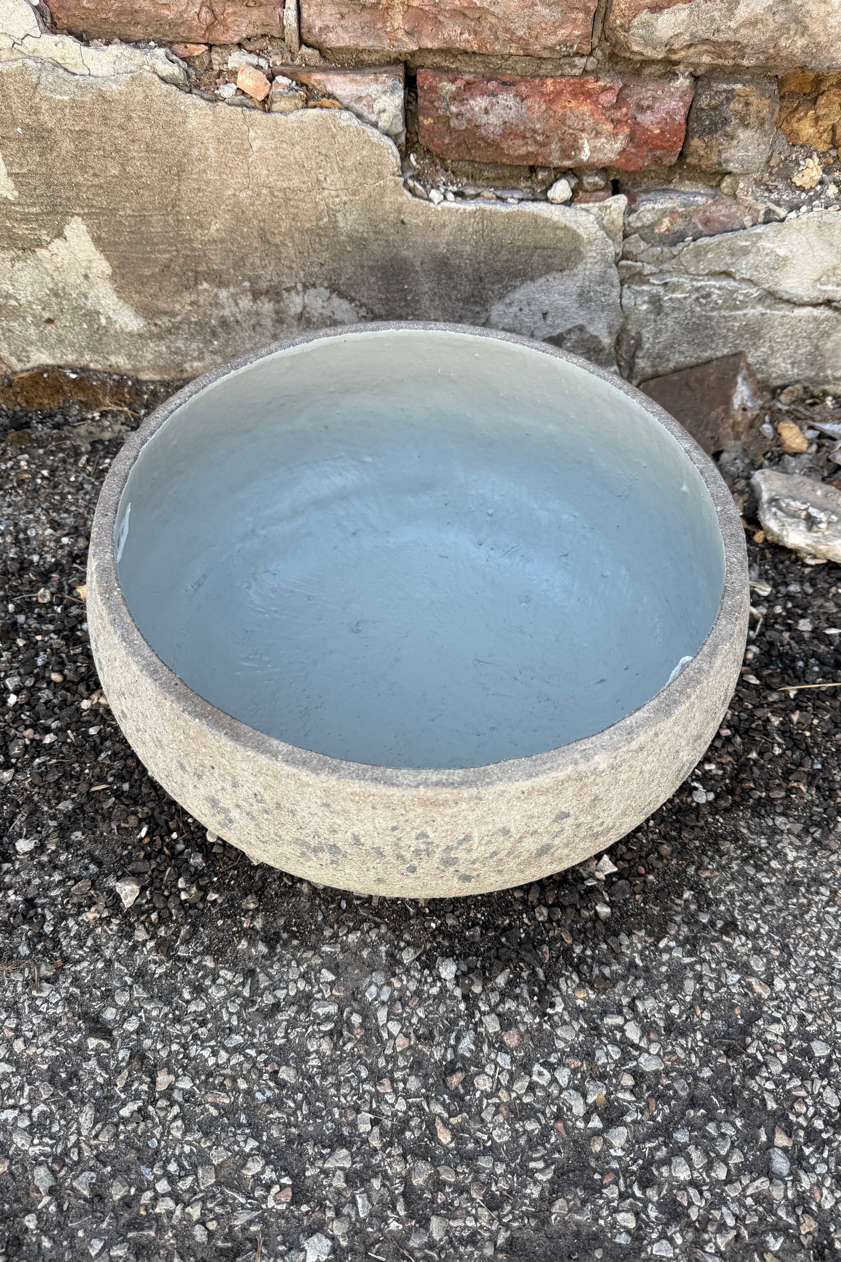 Low Ficonstone Greige Low Bowl Medium on a stone and concrete surface ©Sprout Home