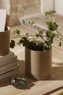 Large Sand colored Sekki Pot by Ferm Living with a plant inside and in a lifestyle shot.