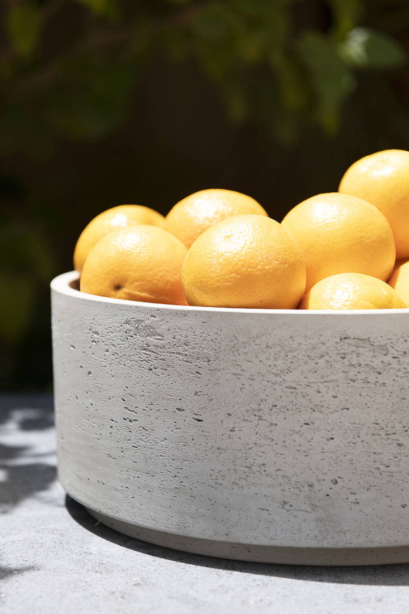 Pottery Pots Grey washed Eli Bowl with oranges housed inside.