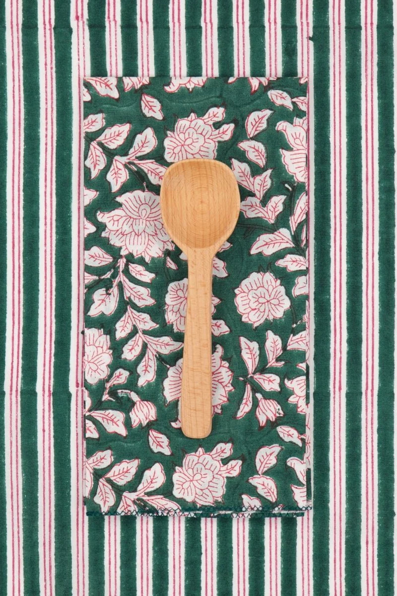 Cotton Napkins Iris Sapin shown with a  striped linen and a spoon ©Suzette a Table
