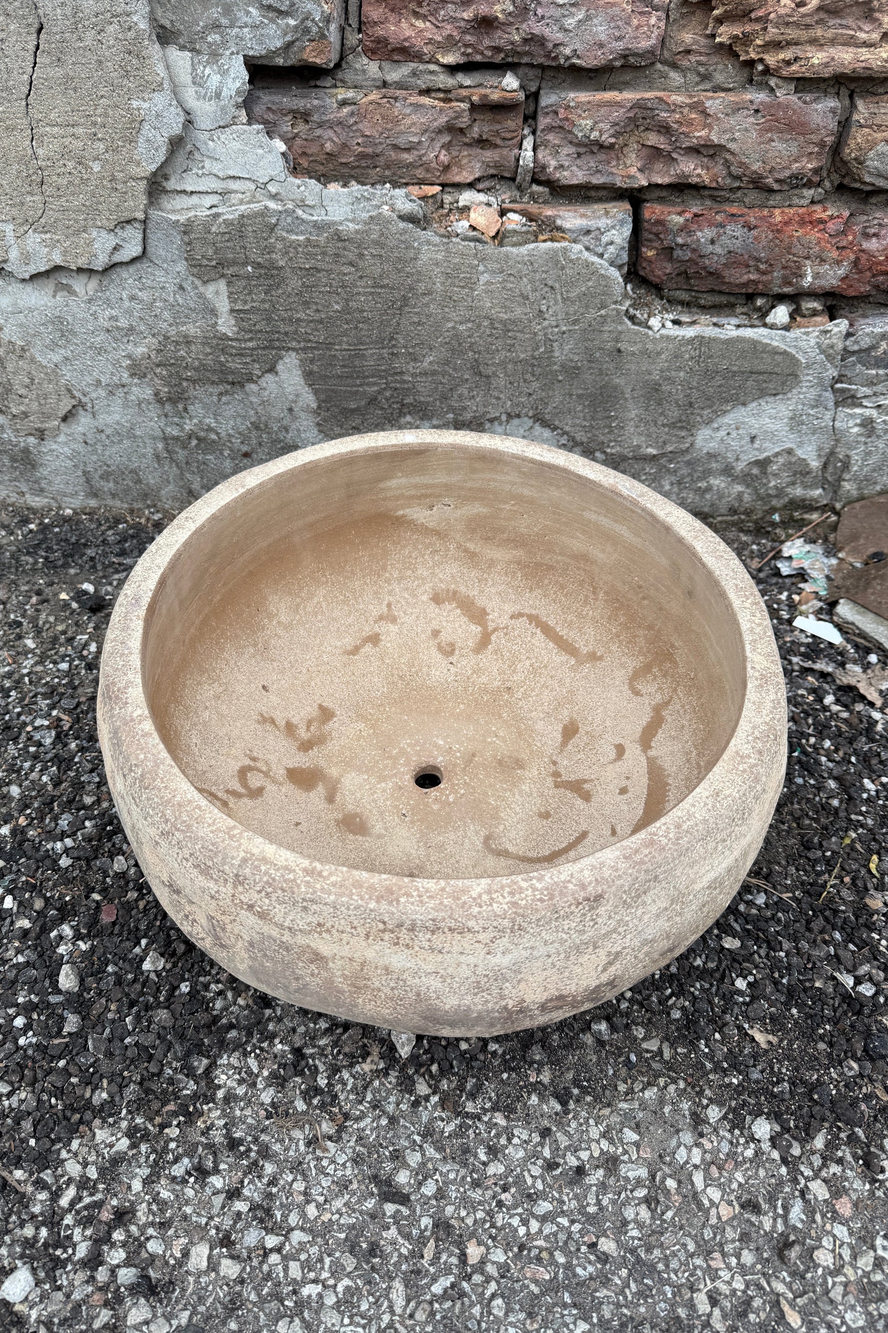 Sansui Tapered Vietnamese Rustic Bowl Large on a stone surface with a stone wall background ©Sprout Home
