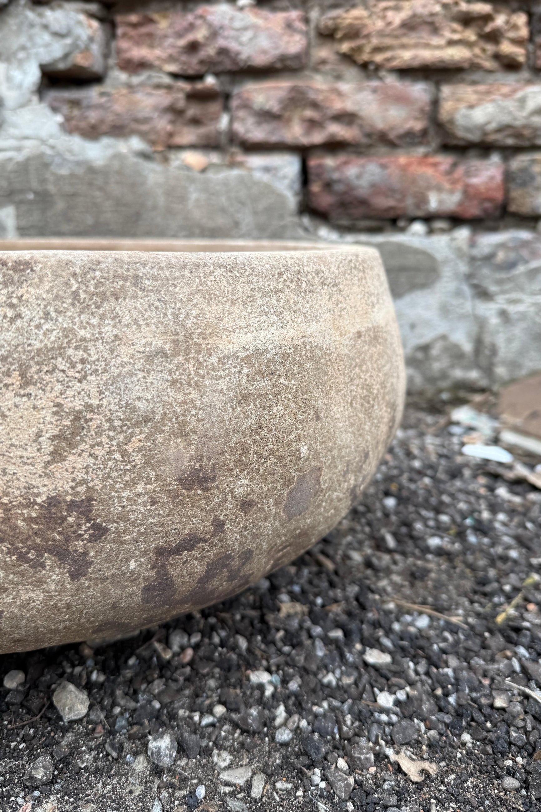 Sansui Tapered Vietnamese Rustic Bowl detail on a street with a stone wall in the background ©Sprout Home