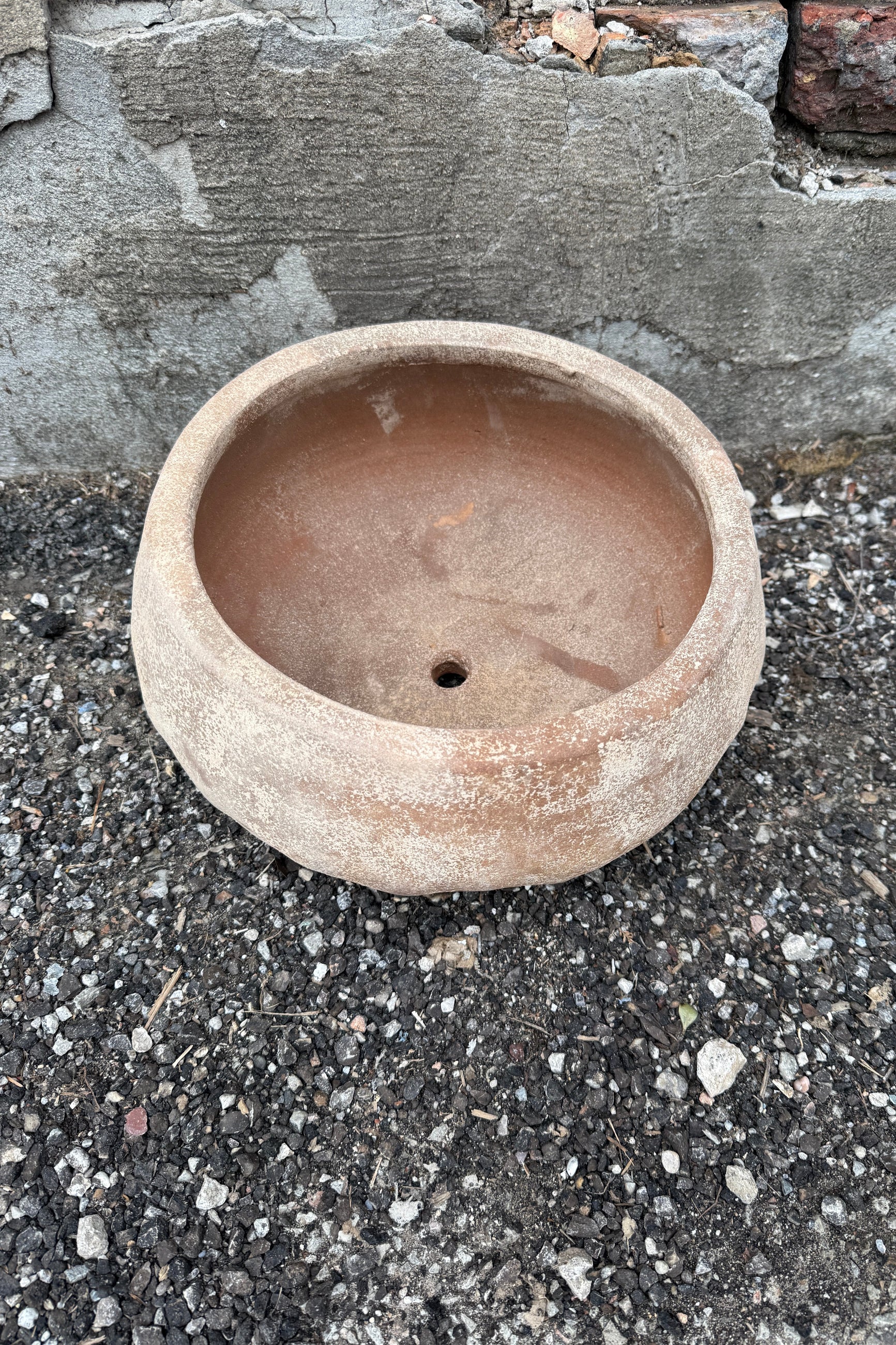 Sansui Tapered Vietnamese Rustic Bowl Mediumon a textured surface with a stone wall background ©Sprout Home