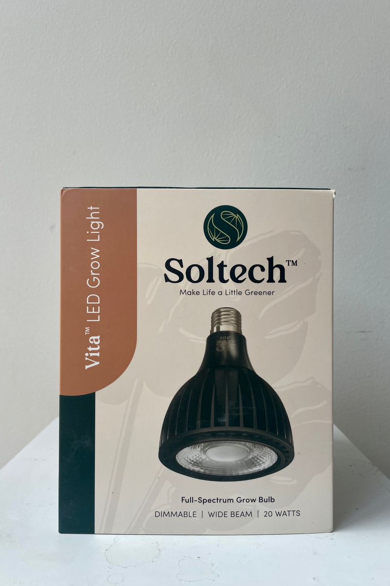 Soltech Solutions Vita grow light bulb in black in the packaging against white wall.