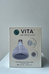 Soltech Solutions Vita grow light bulb in white in packaging against white wall.