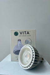 Soltech Solutions Vita grow light bulb in white. Front detail against white wall.
