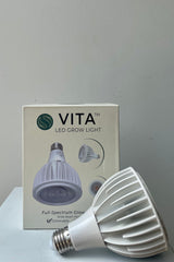 Soltech Solutions Vita grow light bulb in white. Back detail against white wall.