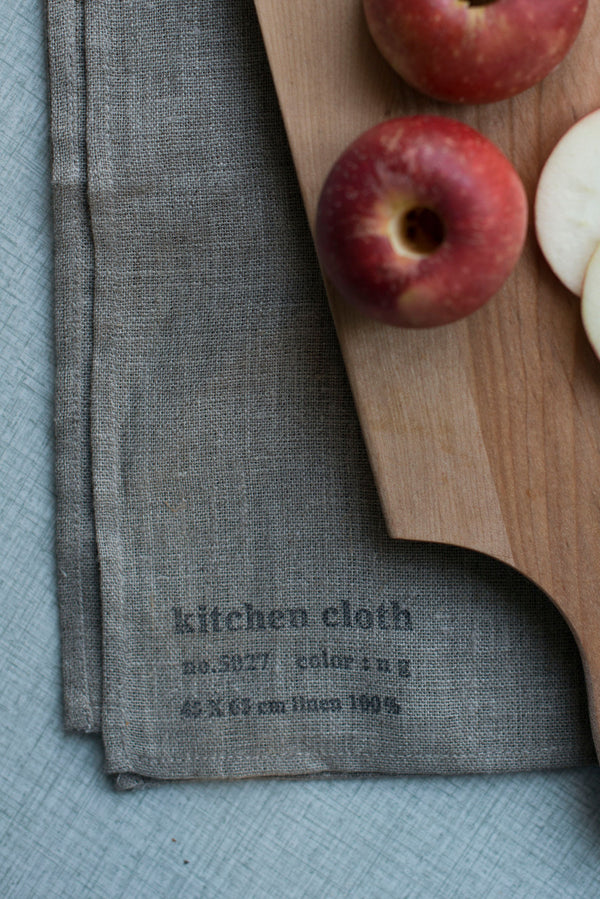 The Natural Linen Kitchen Cloth by Fog Linen Work with a chopping block and apples sitting on it towards the upward right.