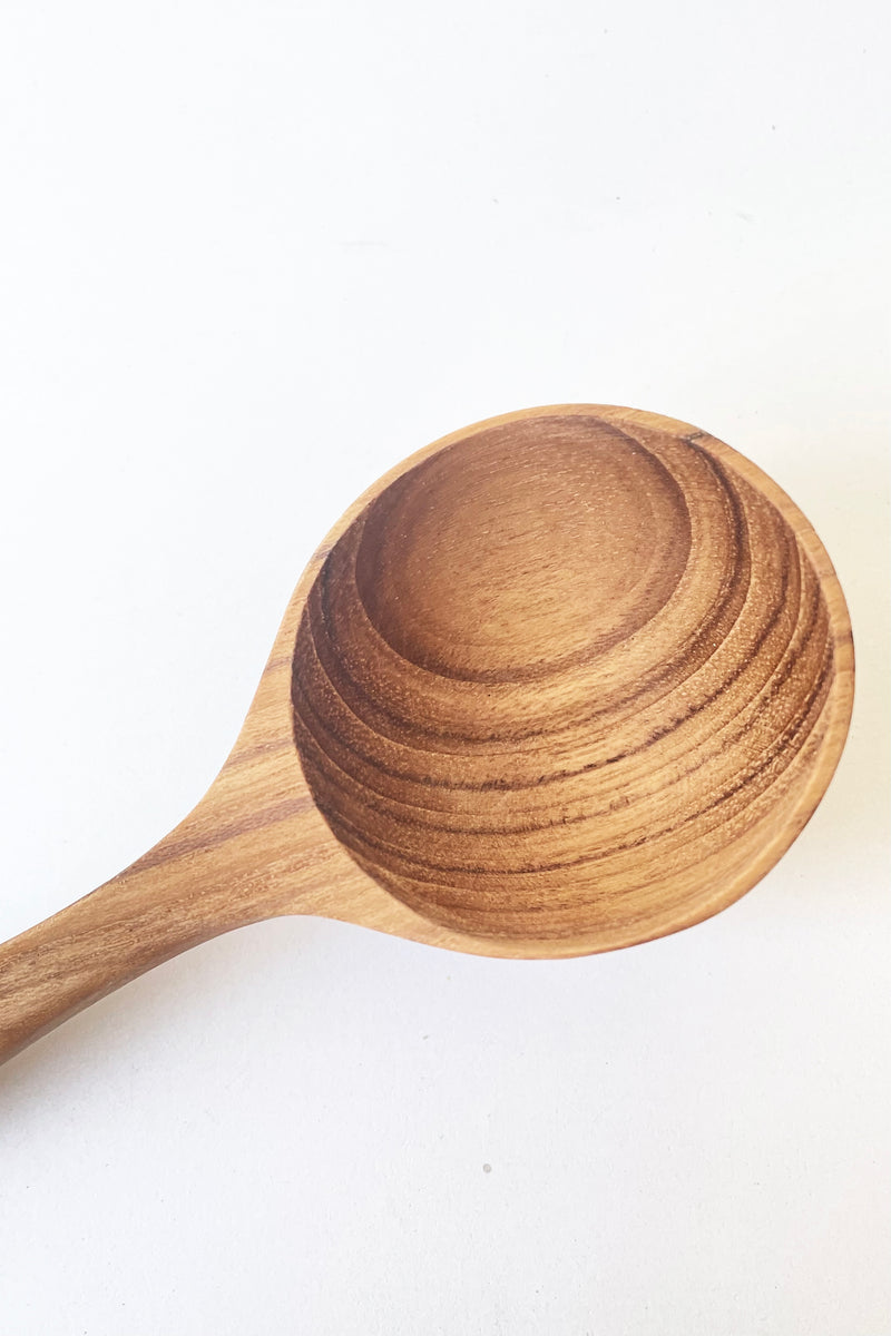 An overhead view of the handcrafted Teak Scoop against a white backdrop