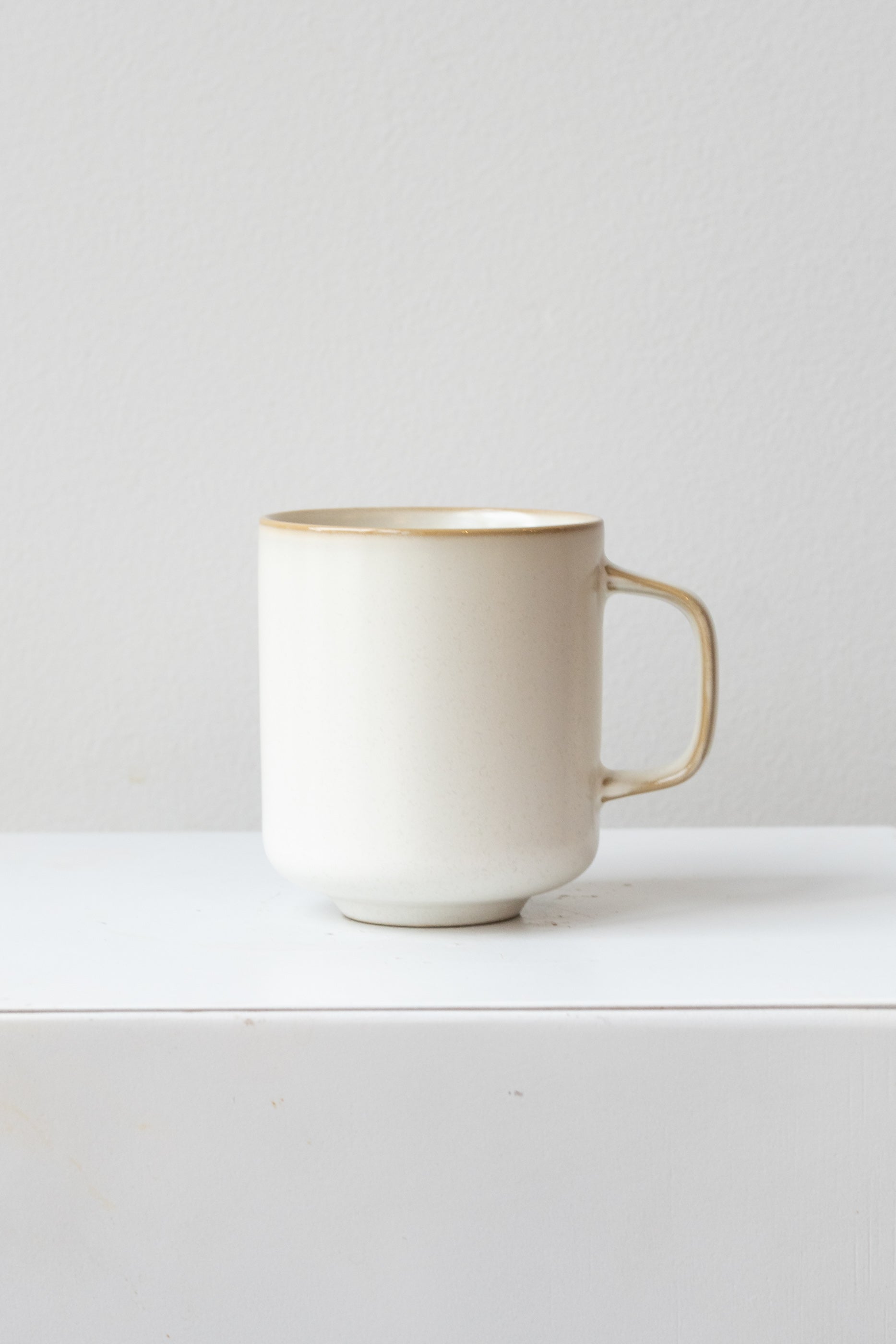 A full-body view of the cream Sekki mug against a white backdrop