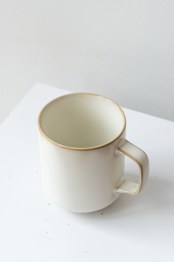 A slight overhead view of the cream Sekki mug against a white backdrop