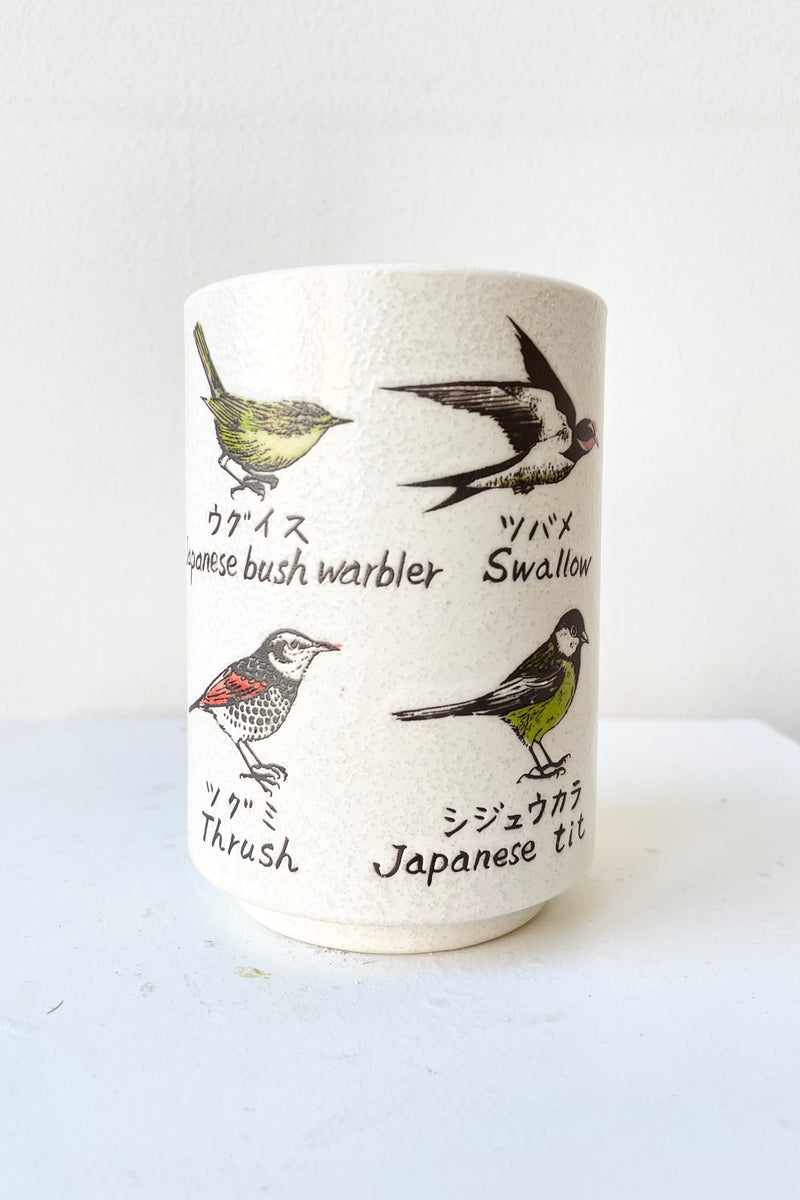 detail of the top of Aviary Cup against a white wall