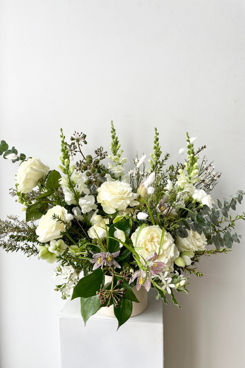 An example of Floral Arrangement Bleached by Sprout Home in Chicago. The arrangement uses primarily white flowers with green foliage.