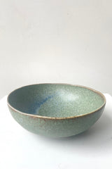 A frontal view of Bowl terra green small against white backdrop