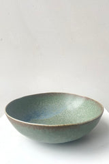A frontal view of Bowl terra green large against white backdrop