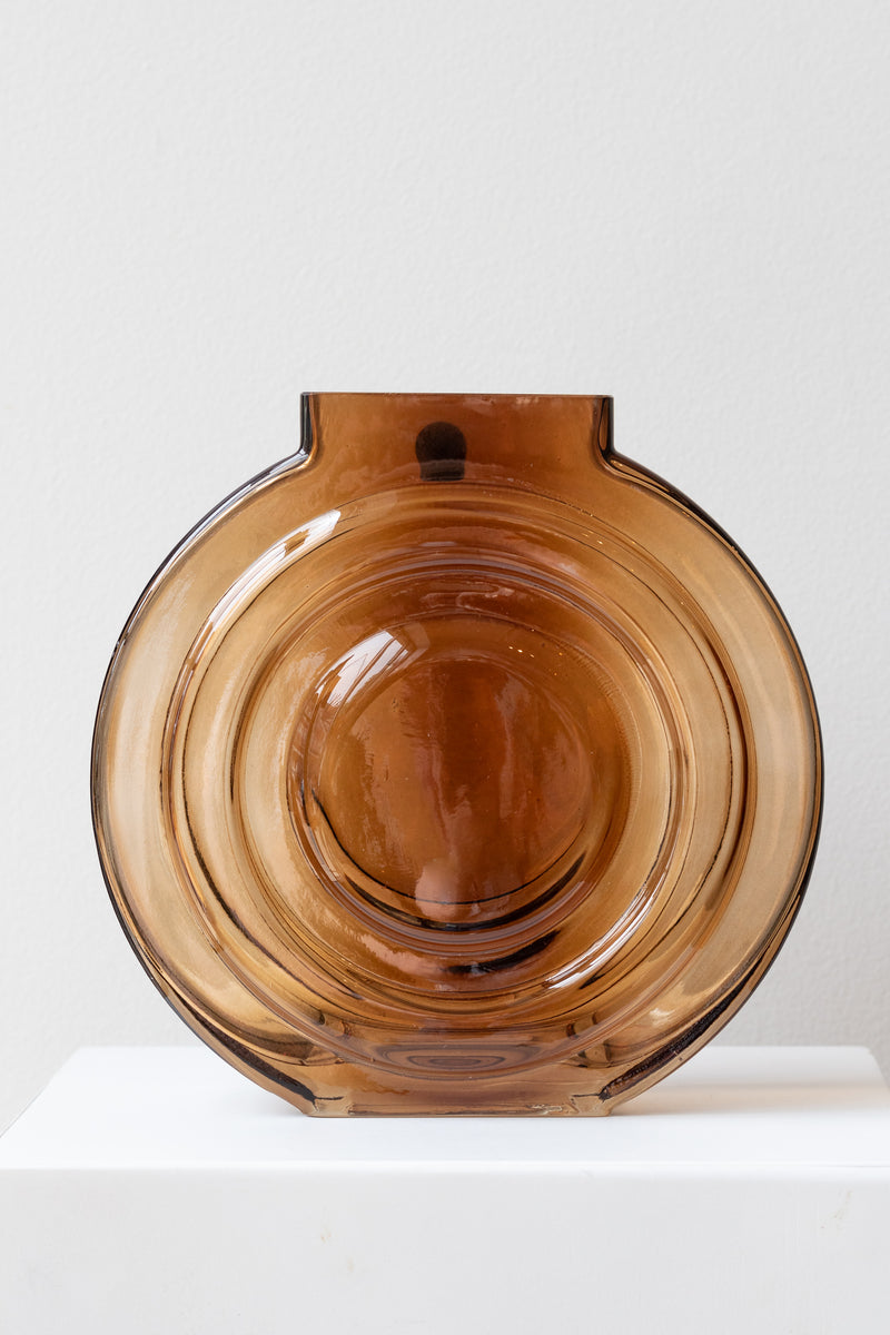 Retro Vase glass amber on white surface in a white room
