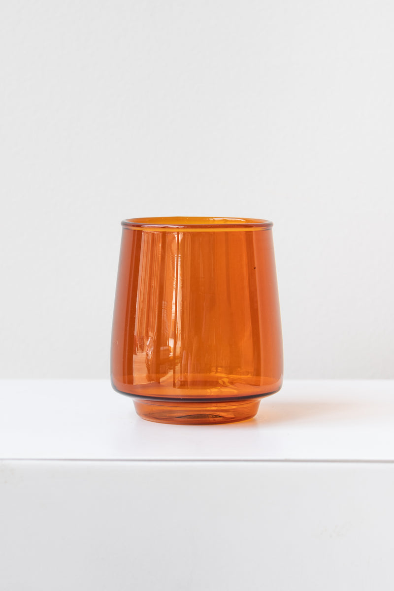 Kinto sepia glass amber tumbler on white surface in white room