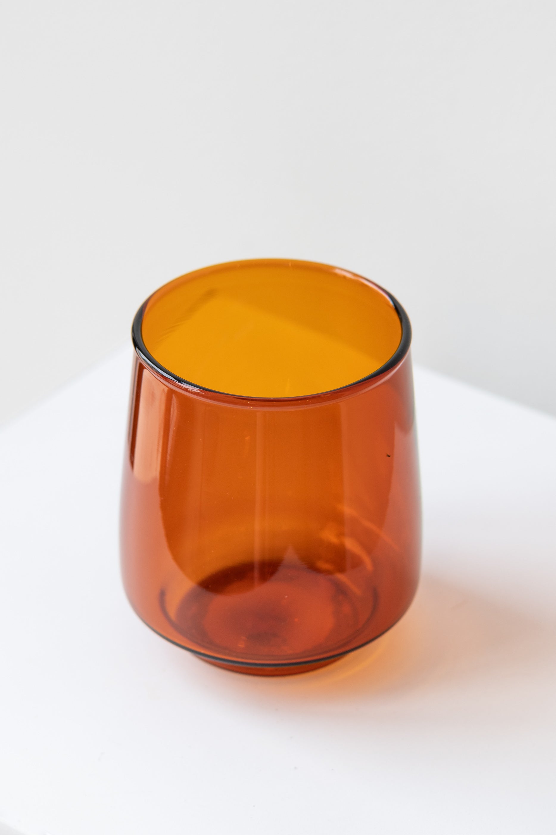 Kinto sepia glass amber tumbler on white surface in white room