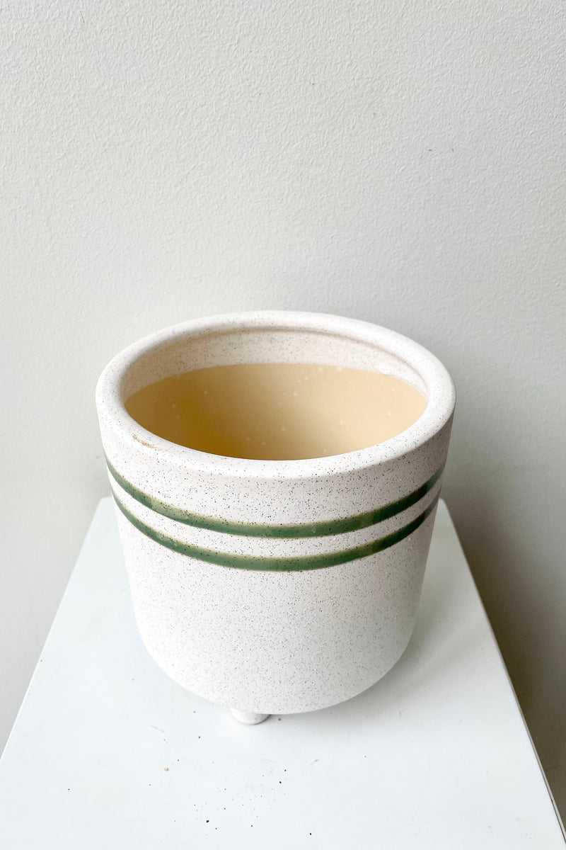Large Fluorite ceramic vessel showing the green stripe and a little bit of the interior against a white wall at Sprout Home.