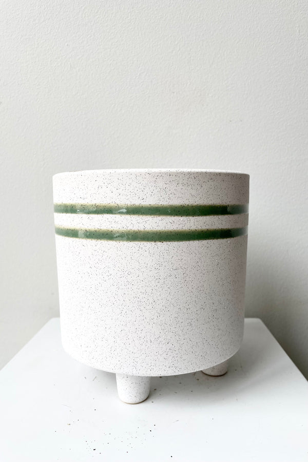 Large Fluorite ceramic vessel showing the green stripe against a white wall at Sprout Home.