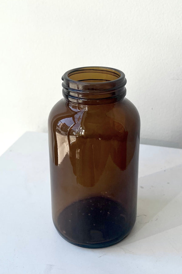 The 250cc Amber Glass Round Bottle against a white backdrop