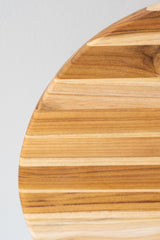 Detail of Teakhaus round medium cutting board wood grain against a white background